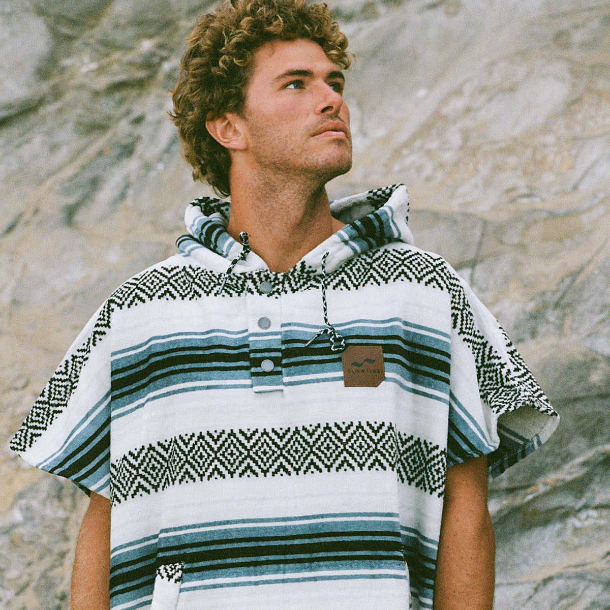 Striped absorbent cotton changing robe with hood, outdoor setting.
