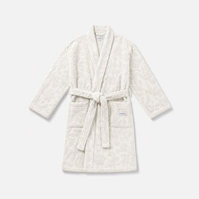 White textured bathrobe with belt and two front pockets for cozy homewear.