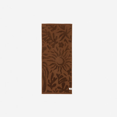 Brown cotton towel with sun-leaf botanical pattern, absorbent 550 GSM.