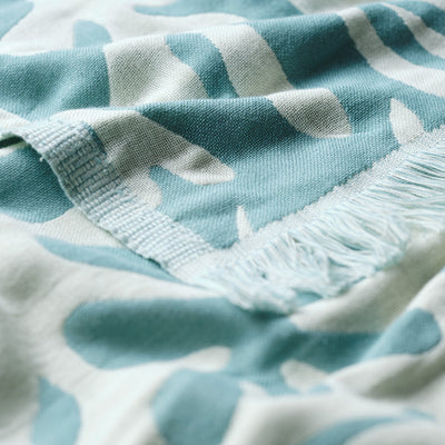 Turkish towel, lightweight cotton, blue and white abstract pattern, close-up view.