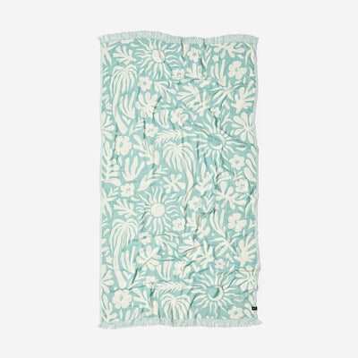 Turkish towel with tropical floral and leaf pattern, lightweight cotton, fringed edges.