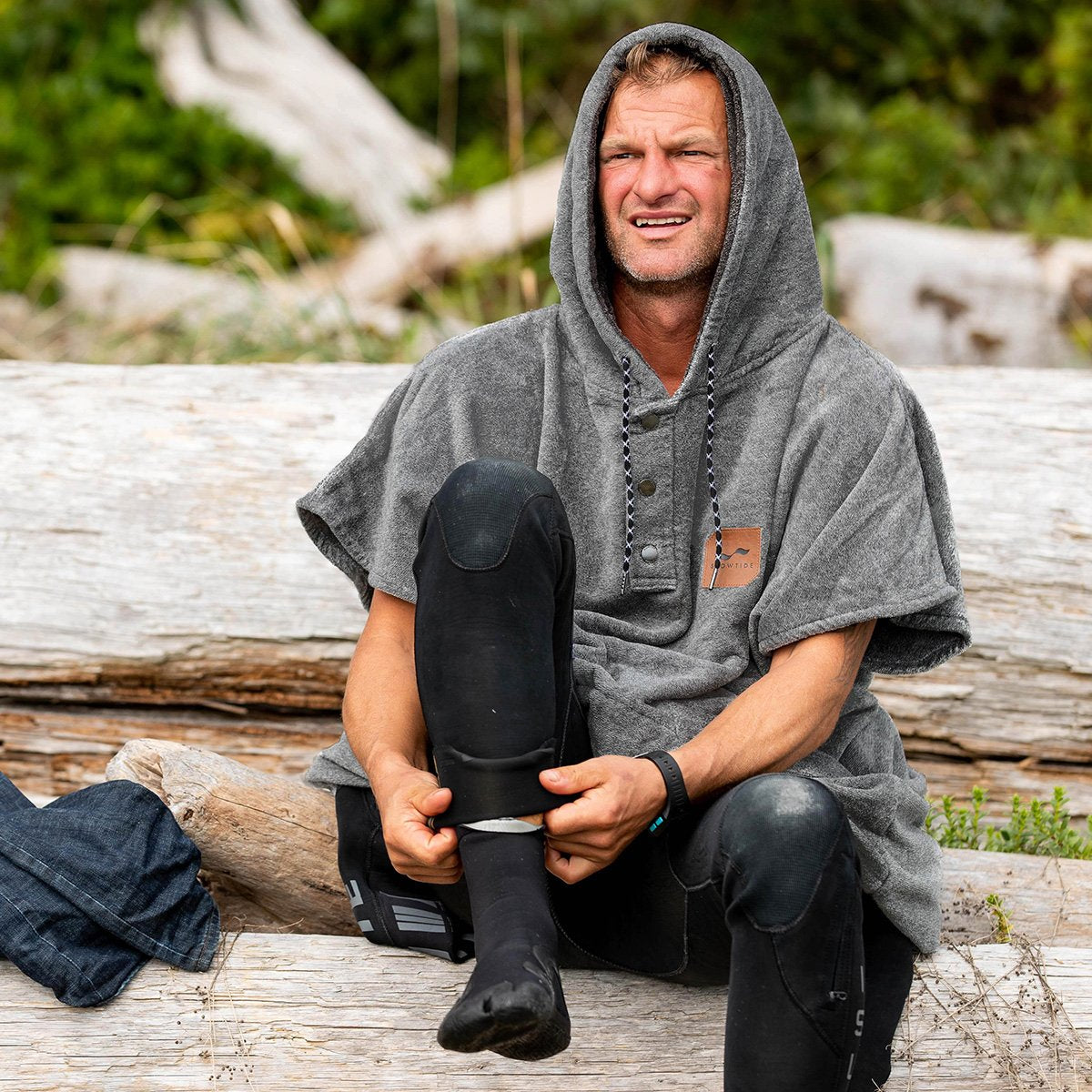 Gray towel poncho with hood, absorbent material, shown with black wetsuit boots.