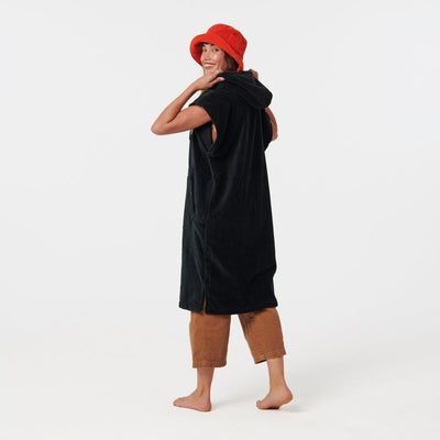 Black hooded changing poncho with front pocket, displayed on model.
