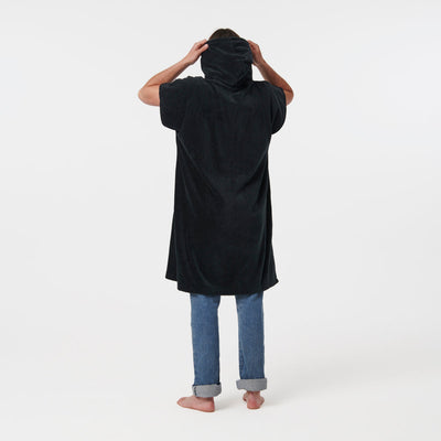Black heavyweight cotton terry changing poncho with jeans, reverse view.