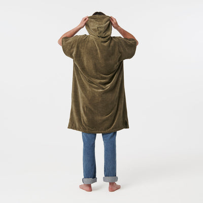 Brown extra-warm towel poncho with textured fabric shown over jeans.