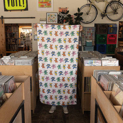 Quick-dry towel made from recycled materials with colorful dancing bears pattern.