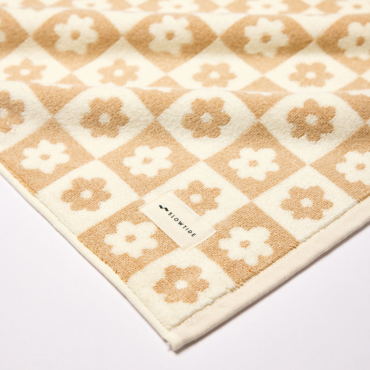 Beige cotton bath mat with checkered floral pattern, 1000 GSM, for bathroom use.