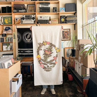 Quick-dry towel with floral and skull design displayed indoors.