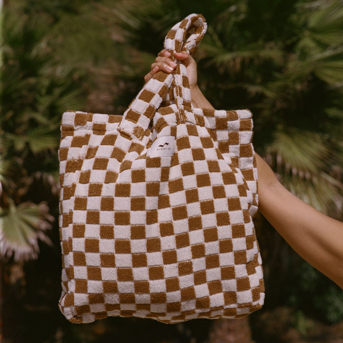 Beach bag with brown and white checkered pattern.